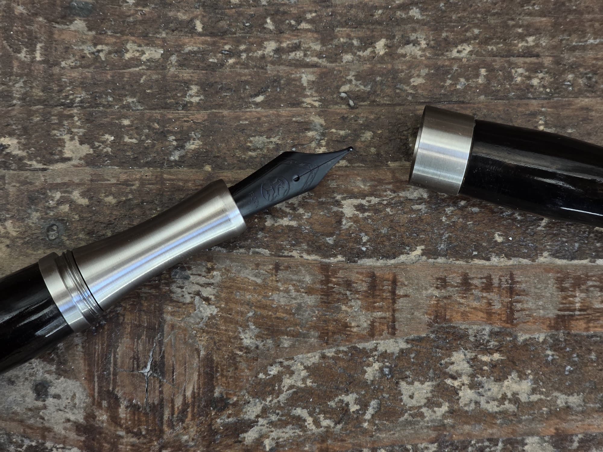 LIGNORAE fountain pen nib photographed on worn wood