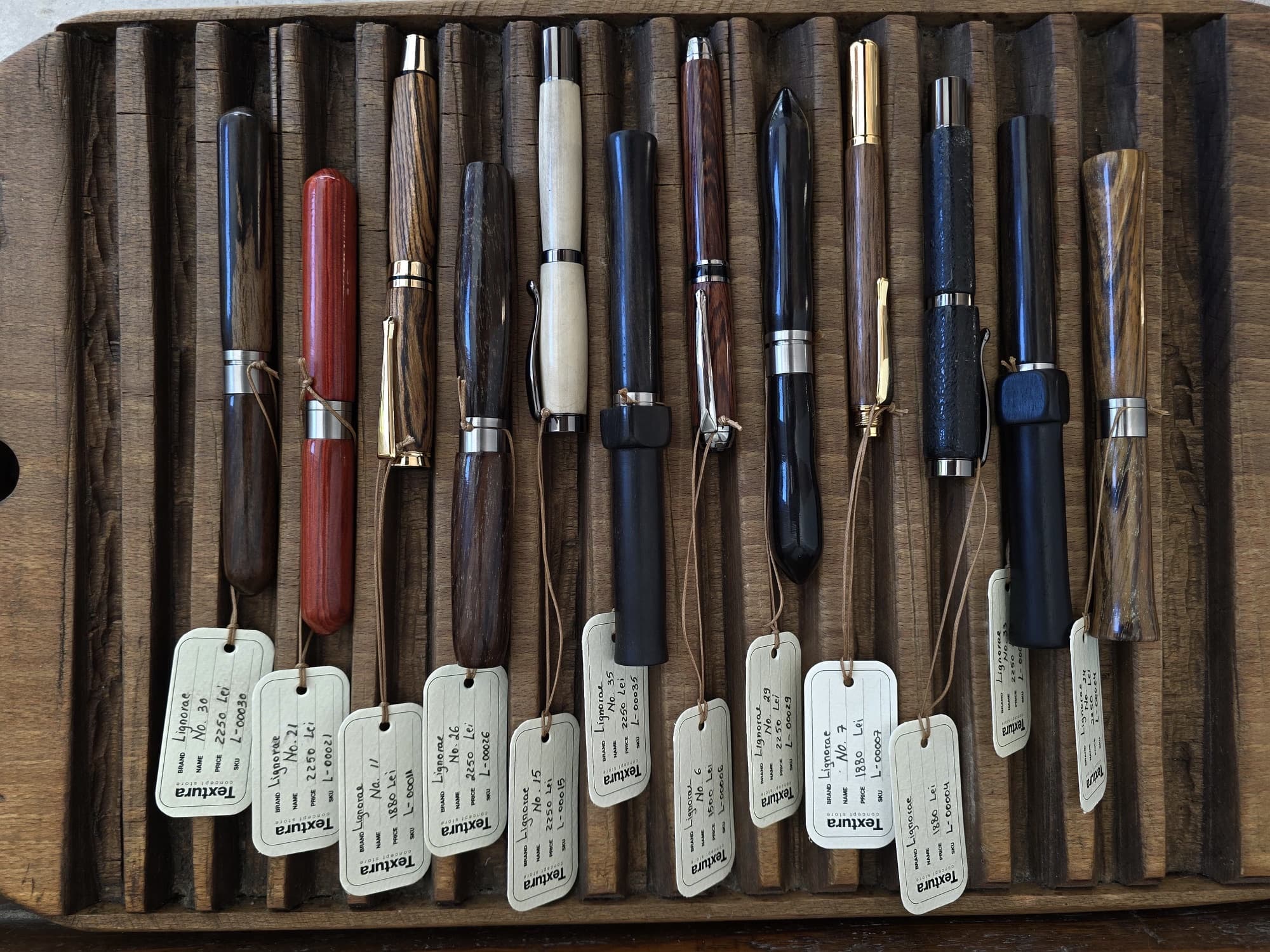 Top view of LIGNORAE writing instruments with numbered TEXTURA tags